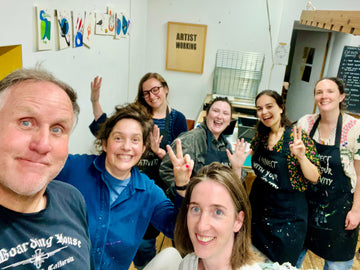 A group of happy people in a art studio set up