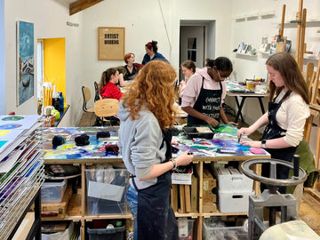 Group of young people in Just Art It studio set up painting on stand up easels