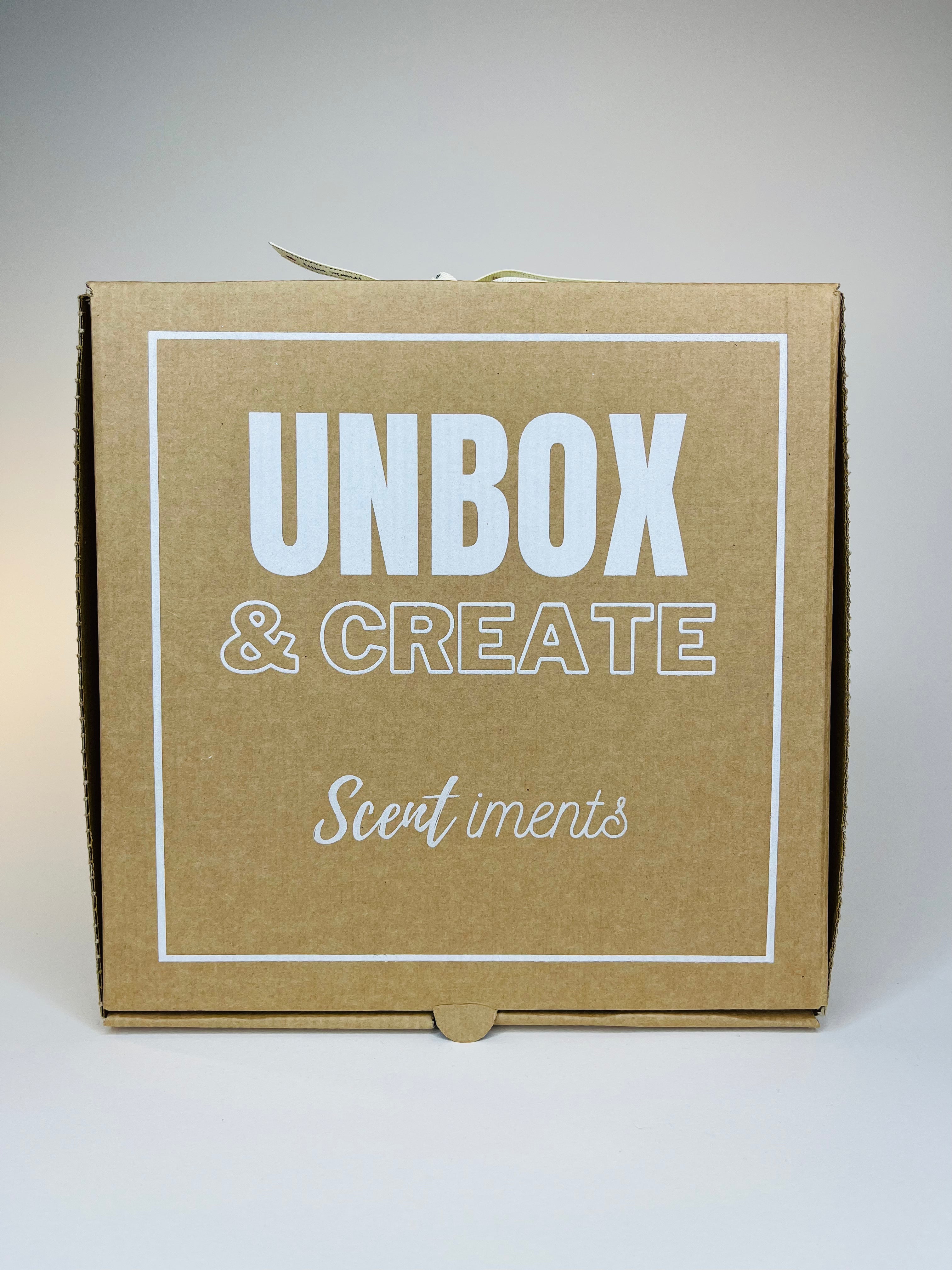 Brown cardboard box with "Unbox & Create" and "Scentiments" in white font.