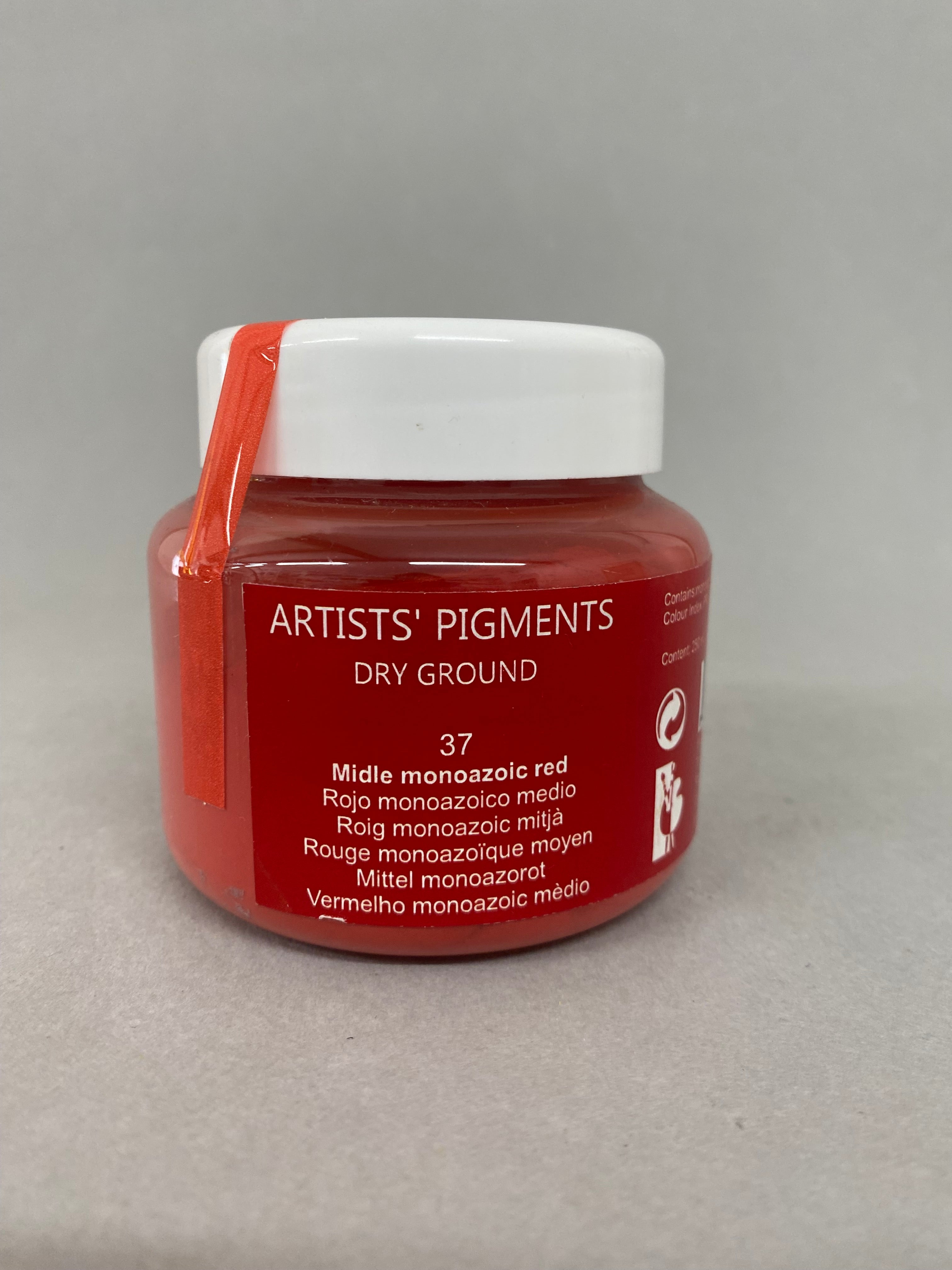 Red jar of Artists' Pigments dry ground on a gray background