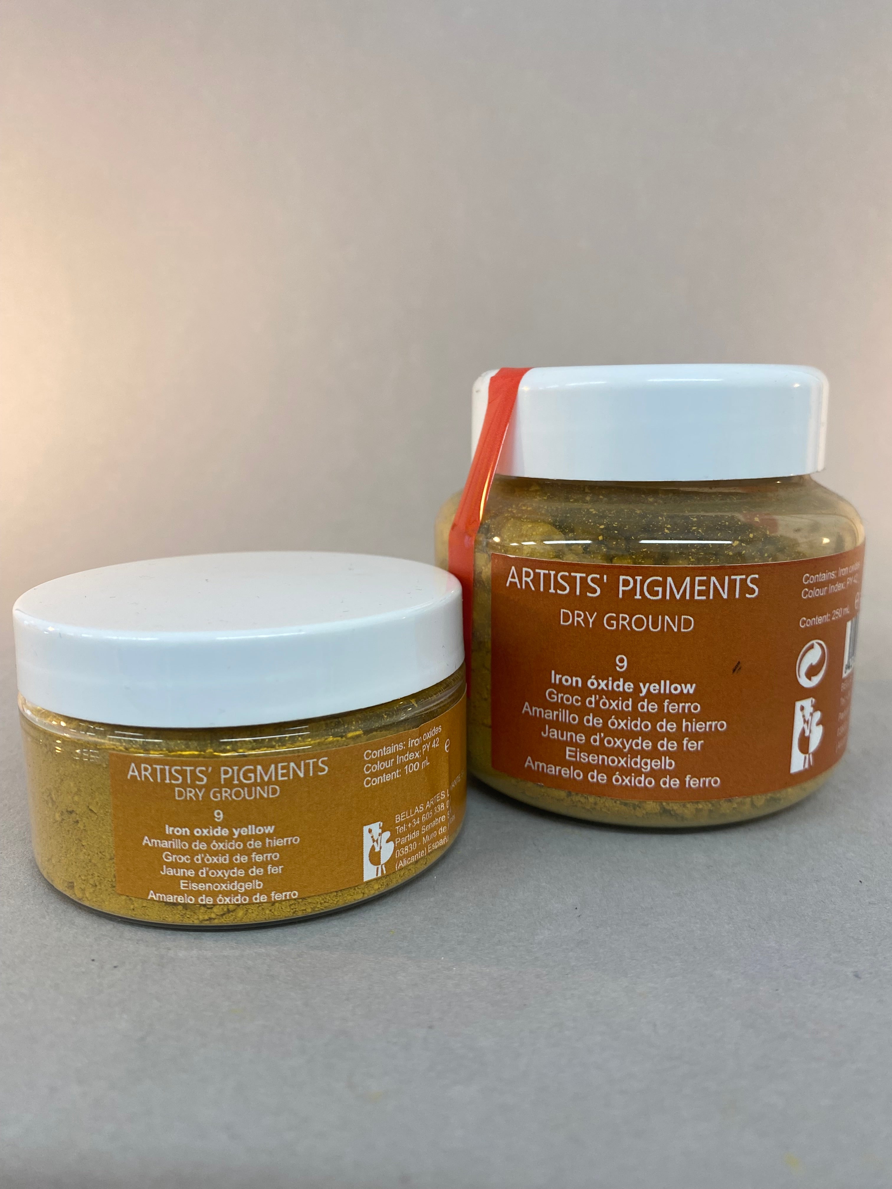 Two jars of 'Artists' Pigments' on a gray background
