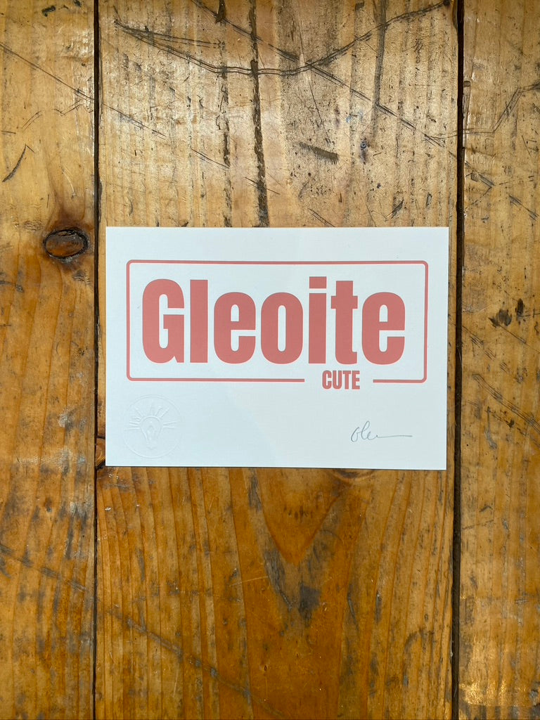 screen print on white paper with 'Gleoite' printed on it against a wooden background