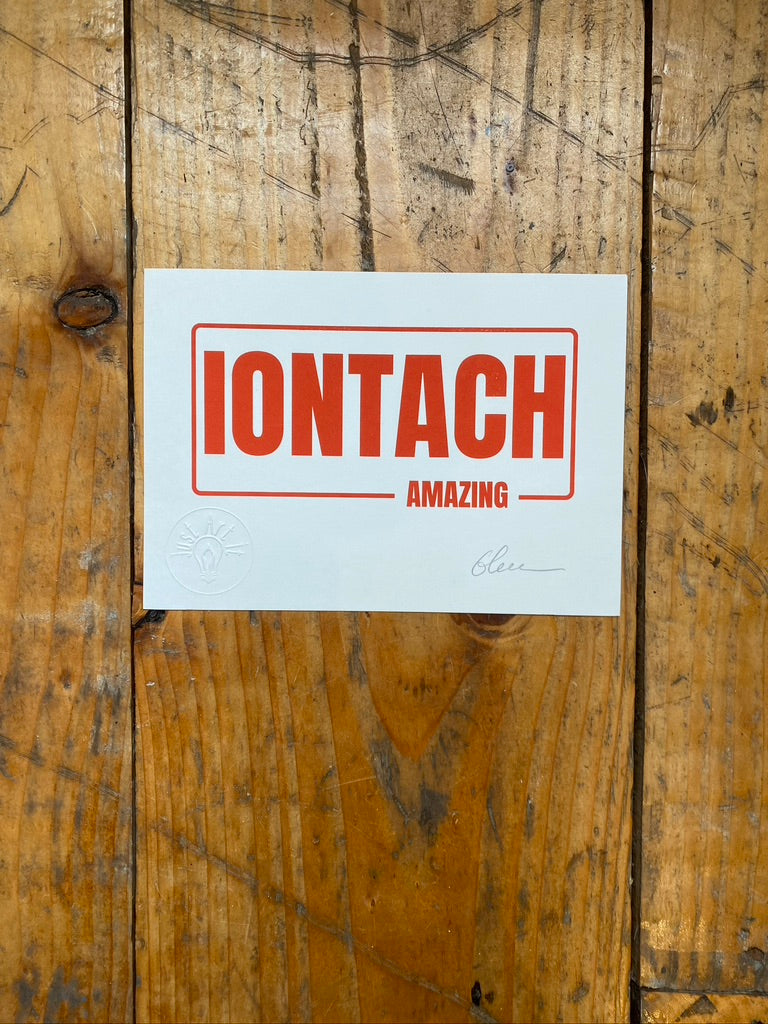 Screenprint on white paper with 'IONTACH' and 'AMAZING' text on a wooden floor