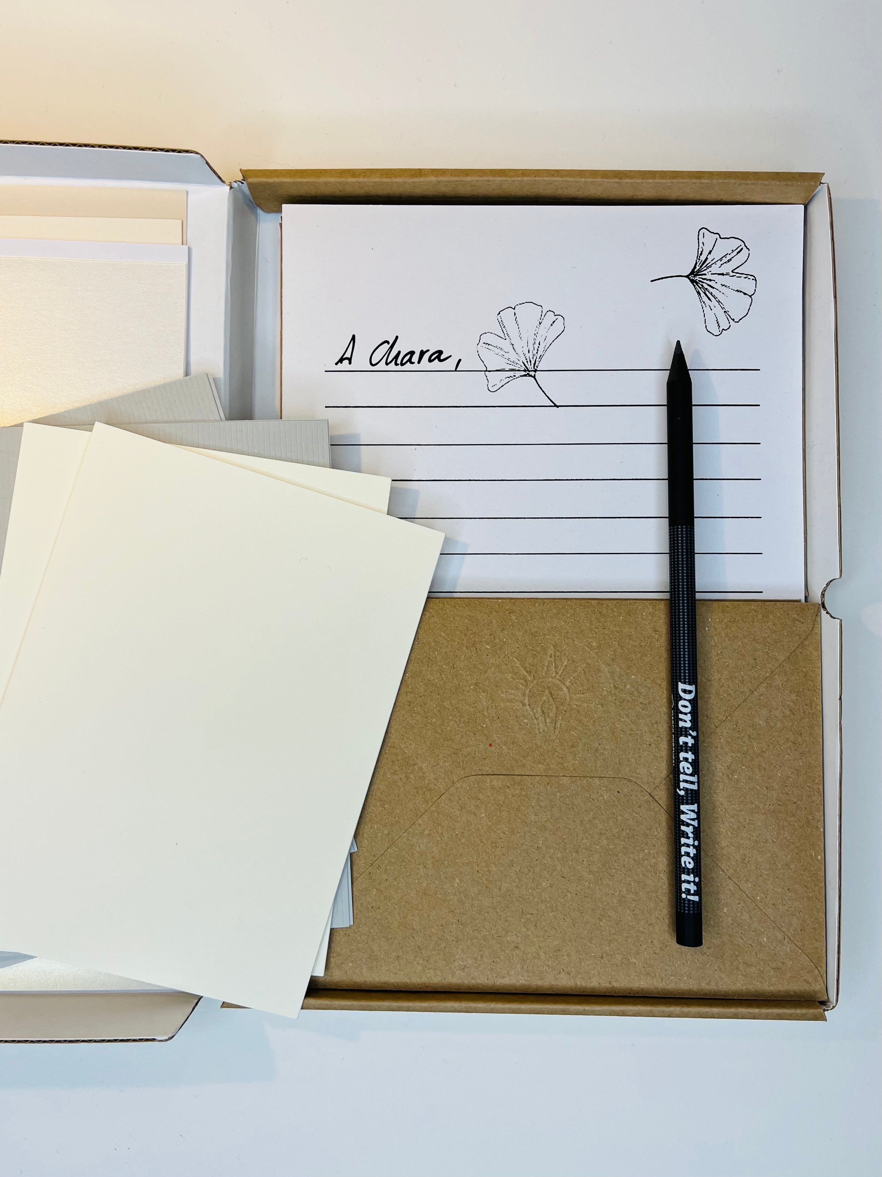 Stationery set in a box, including lined paper, envelopes, blank cards, and a pencil.