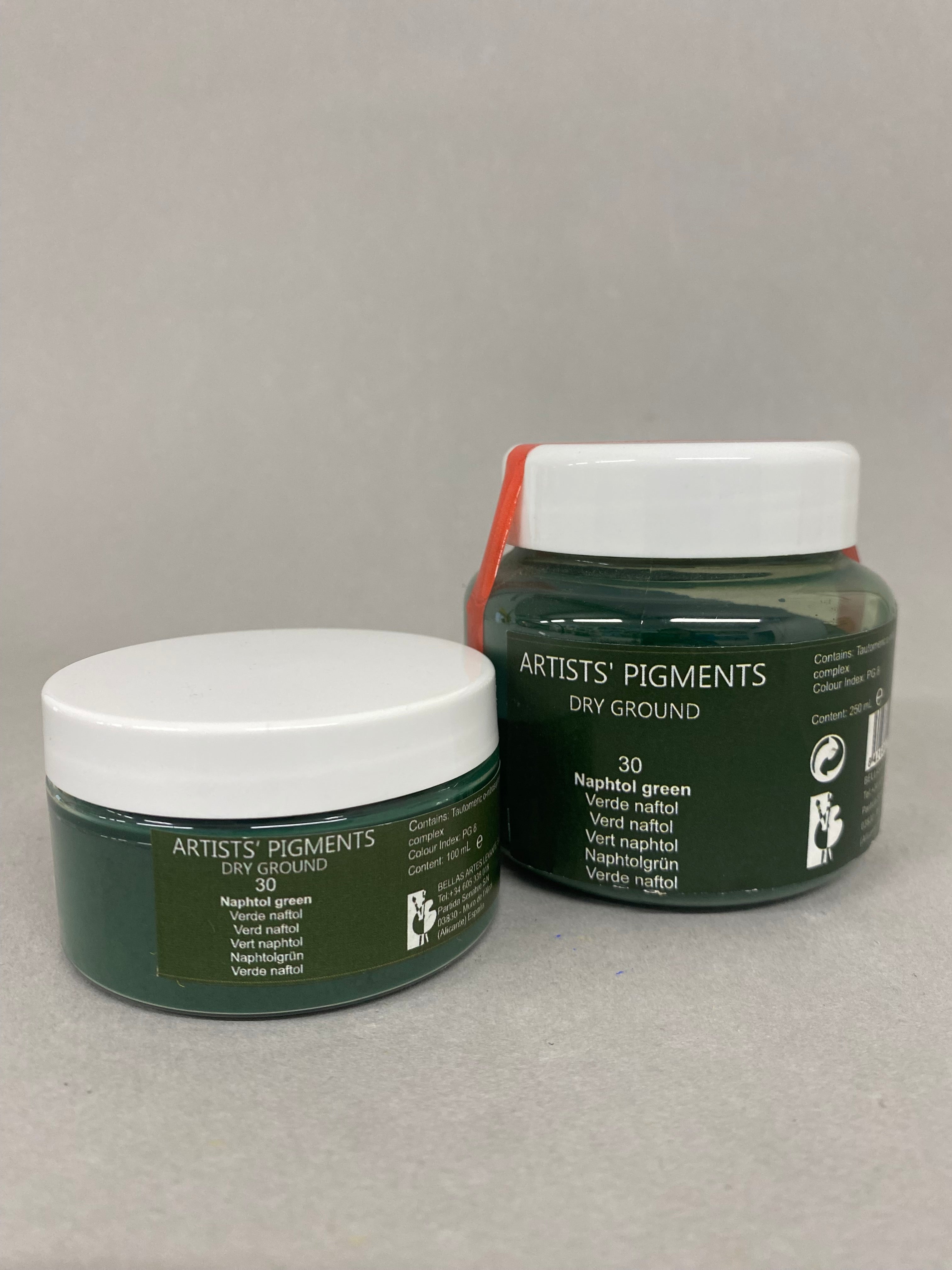 Two jars of 'Artists Pigments' on a gray background